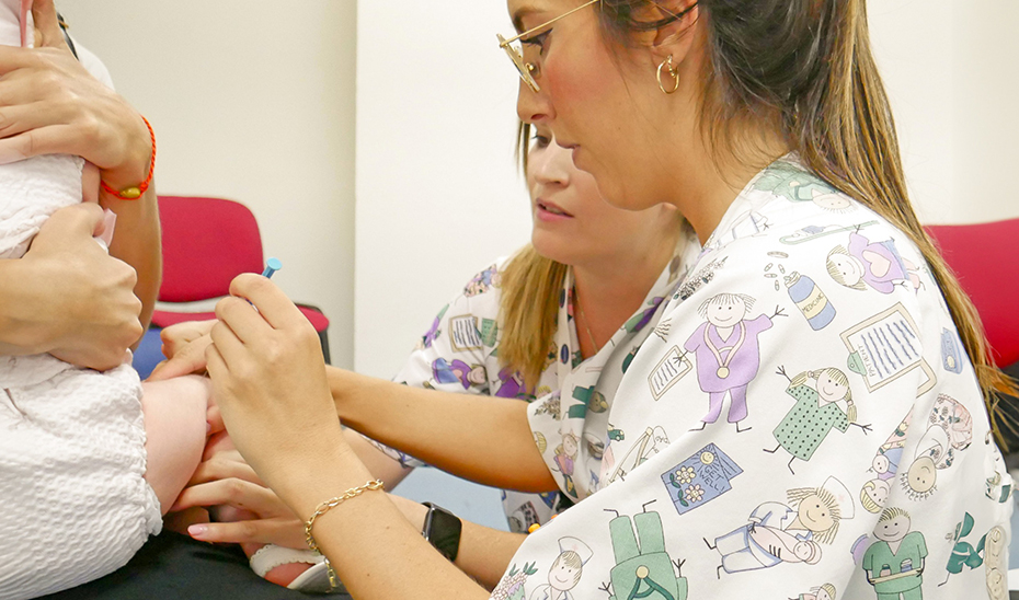 Una enfermera administra a un niño la vacuna frente al Virus Respiratorio Sincitial.